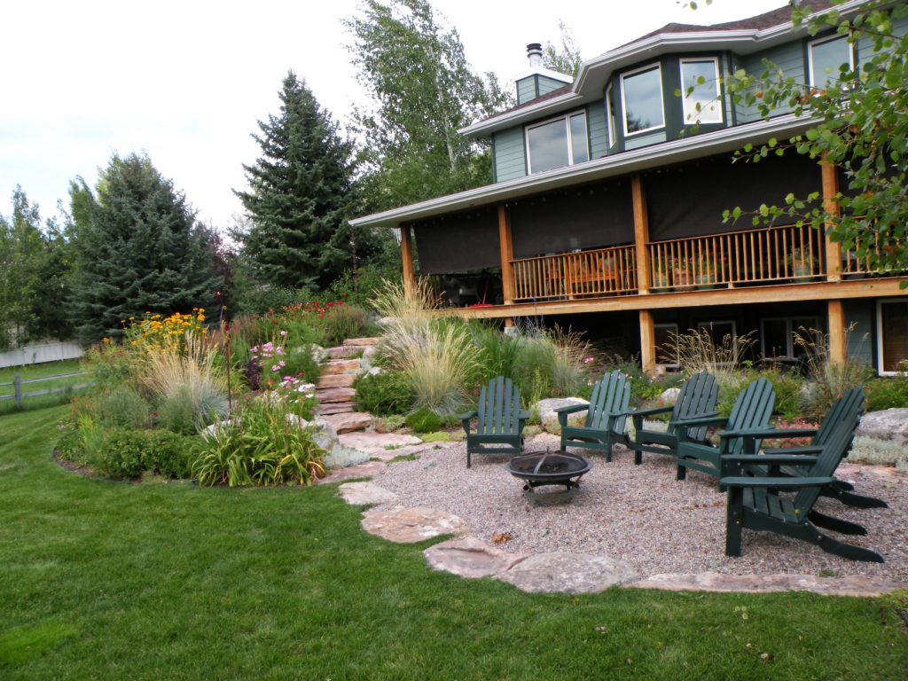 Pea gravel sitting area with flagstone border and steps accent this perennial garden Bozeman's south side.