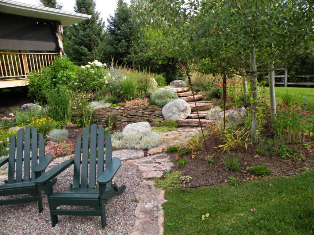 Pea gravel sitting area with flagstone border and steps accent this perennial garden Bozeman's south side.